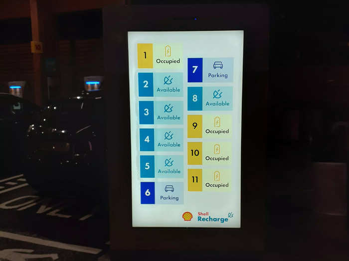 A digital sign shows drivers which charging bays are occupied and which are available