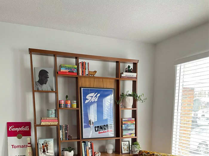 She styled the shelving unit with books, art, and more plants.