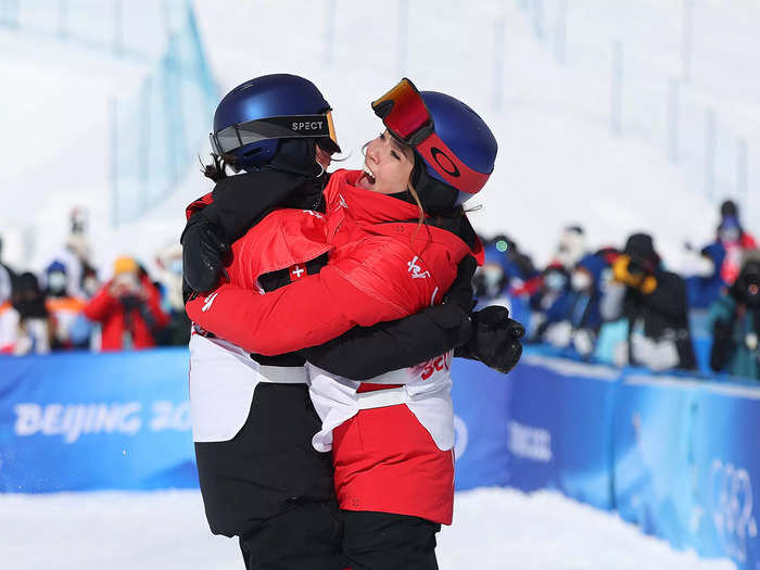 2/15: Gold medalist Mathilde Gremaud (left) of Team Switzerland and silver medalist Eileen Gu of Team China jump while hugging after winning their medals during the Slopestyle Final on Day 11 of the Beijing Olympics.