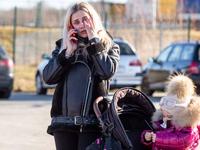 Photographers captured emotional scenes as the first wave of refugees arrived in Poland on Thursday.