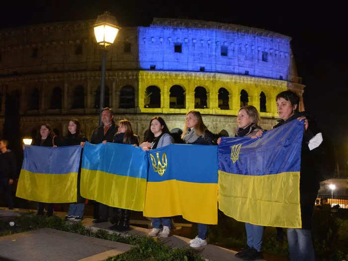 On Thursday, demonstrators held Ukrainian flags in front of the Colosseum in Rome, which also had a Ukrainian flag projected onto it.