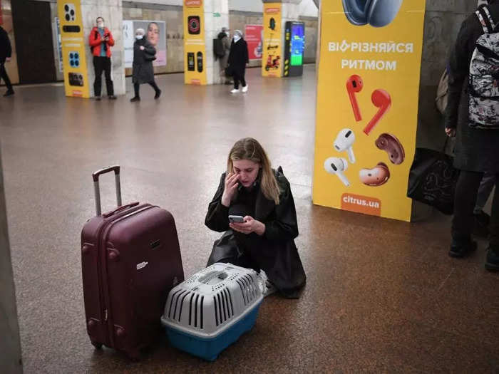 At a metro station in Kyiv, a woman wiped a tear as she checked her phone, cat carrier in tow.