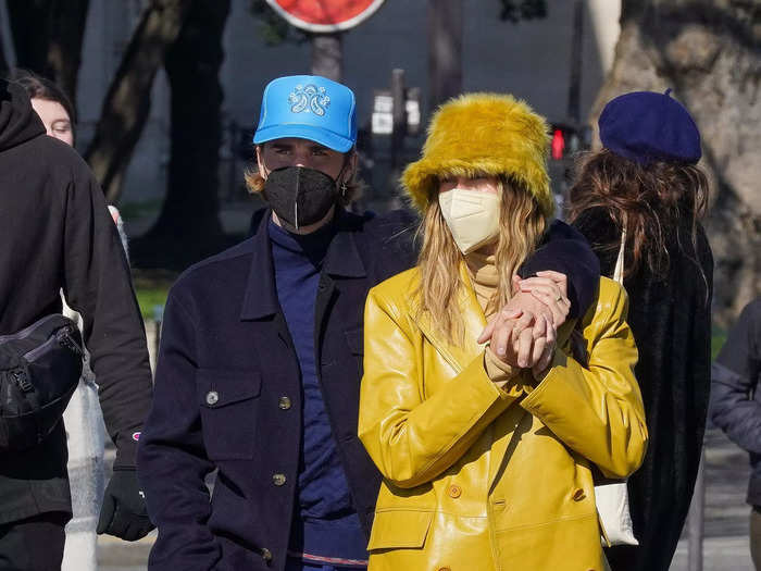 During Paris Fashion Week on February 28, 2021, the Biebers each wore monochromatic outfits: Justin in blue, Hailey in mustard yellow.