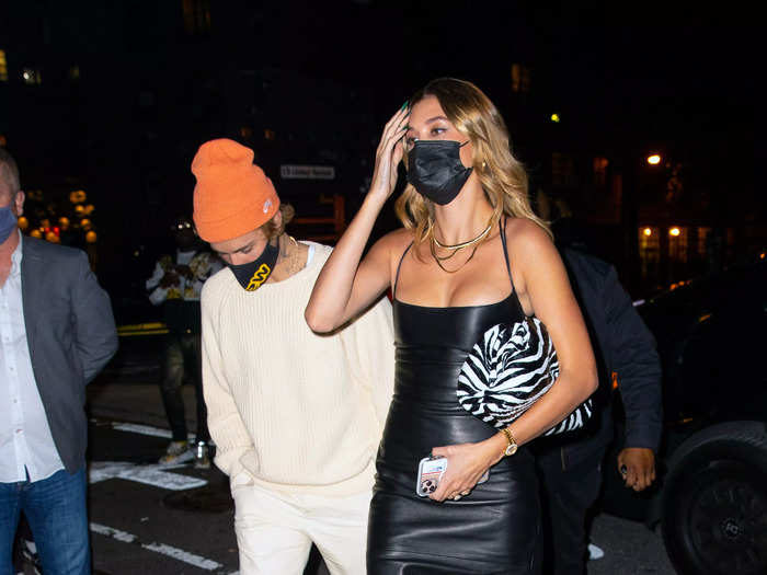 Two days later, Hailey donned a calf-length leather dress and zebra-print purse. Her husband, casual as ever, went for a cream sweater, white pants, and an orange beanie.