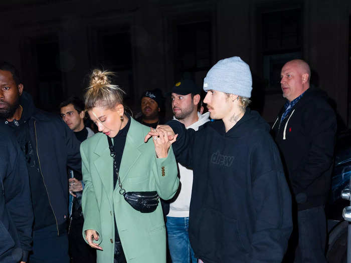 Later that night, Hailey made an outfit change, switching out the black coat for a mint green one. Justin kept his PJ pants, but switched his socks, shoes, and added a sweatshirt and beanie.