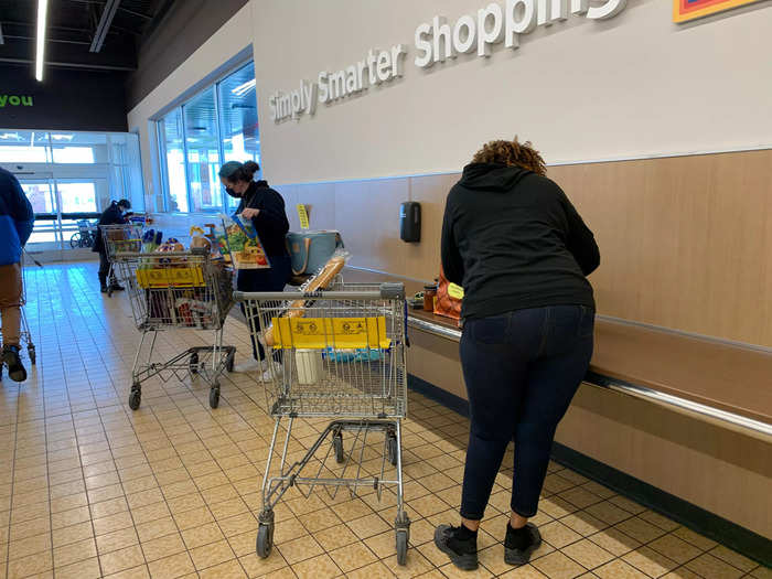 Customers can take their carts to a shelf against the back wall and bag groceries themselves into reusable bags Aldi sells or free boxes to carry heavy items.