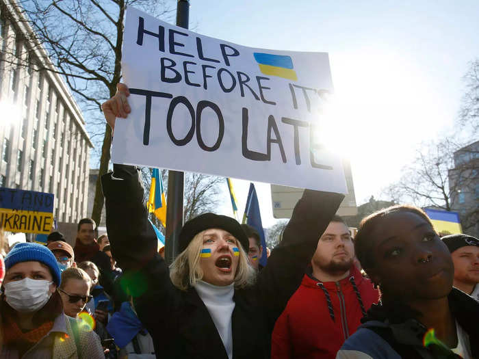 Protesters in Brussels held up signs that read "Russian warship go f**k yourself;" "I