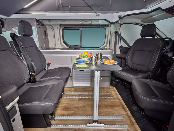 The front driver and passenger seats can swivel to face the interior, turning the movable table into a small dining space for a family of four.