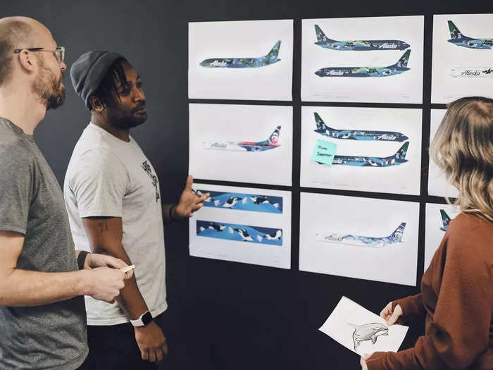 The final livery was chosen from three designs, each created by a different Teague artist. It features an ocean scene with shades of green and blue, and orcas swimming through the water and popping through the surface on the tail.