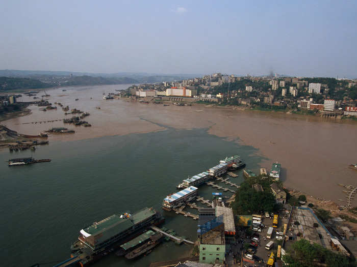 Chongqing has historically been an industrial city; a photo from 1997 (below) shows densely packed buildings and a bustling port.