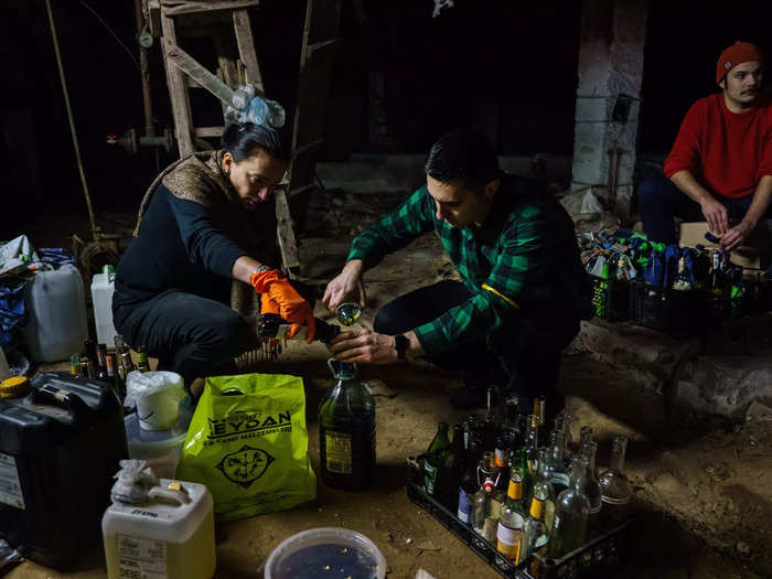 Across Ukraine, civilians are making Molotov cocktails in preparation for battle