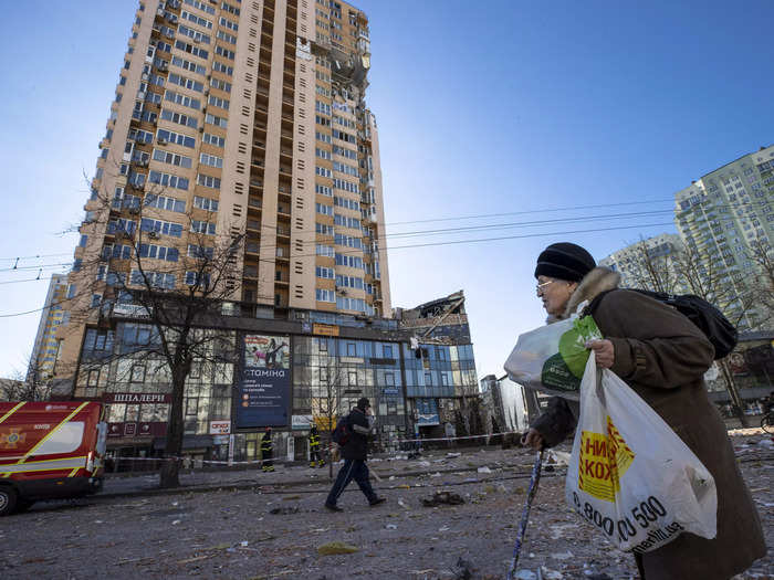 Citizens made their way past damaged buildings to visit stores.