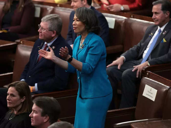 Rep. Lisa Blunt Rochester of Delaware wore a teal skirt suit with a blue and yellow ribbon on her lapel.