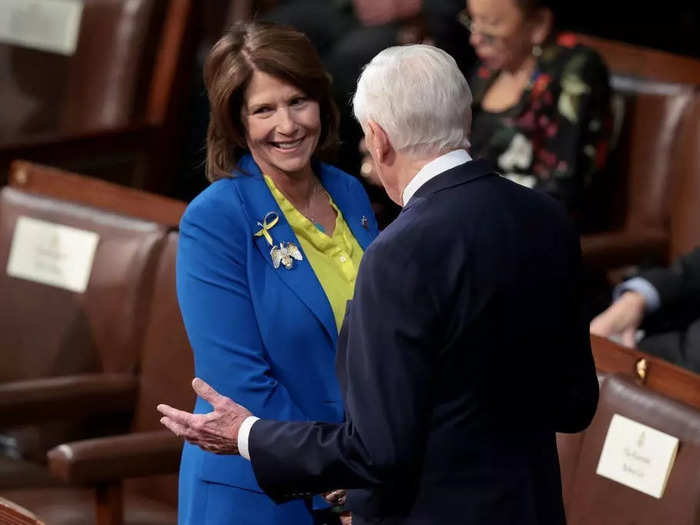 Rep. Cheri Bustos of Illinois also layered a blue blazer over a yellow top.