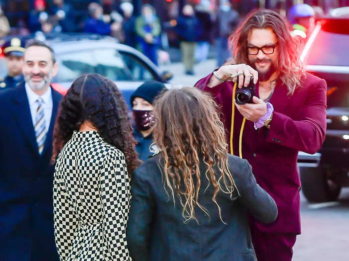 Momoa took photos with, and of, his children at the event, capturing an image of them with a camera on the street.