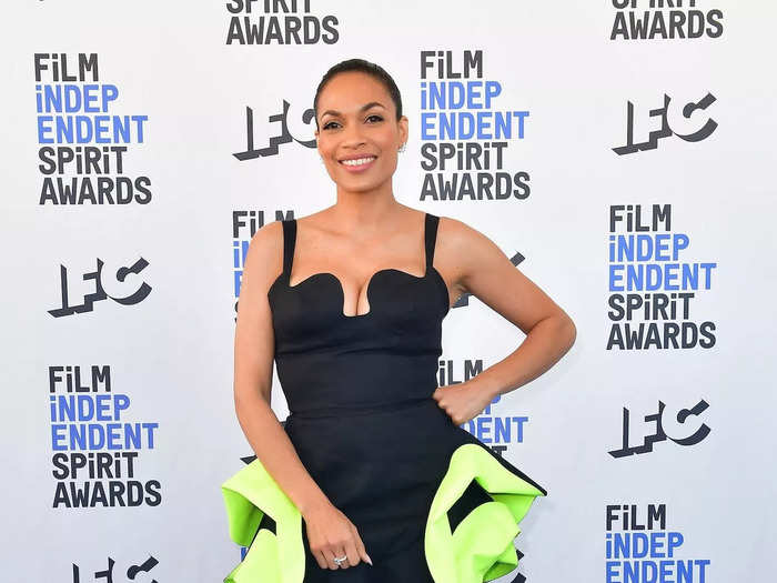 Rosario Dawson opted for a minidress with an asymmetrical neckline and neon-green accents. To make the outfit more unique, she also added black tights.