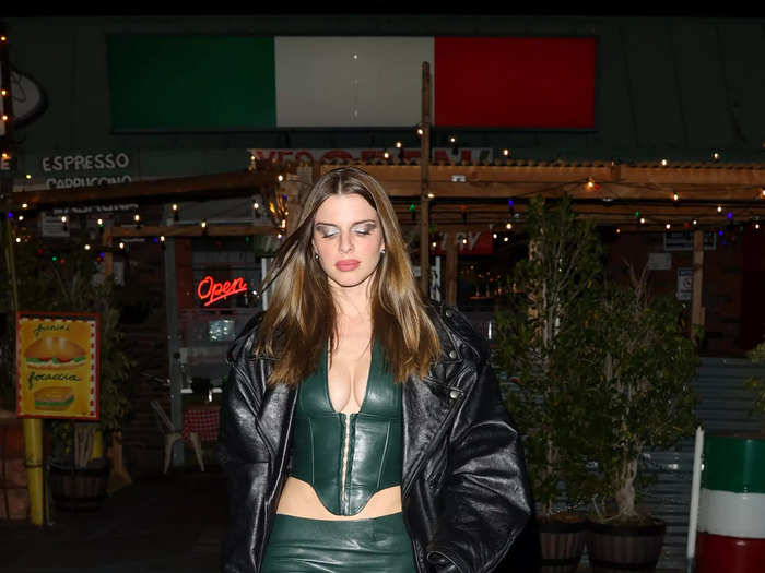 While out to dinner in Los Angeles, the actress wore a matching green leather corset and mini skirt.