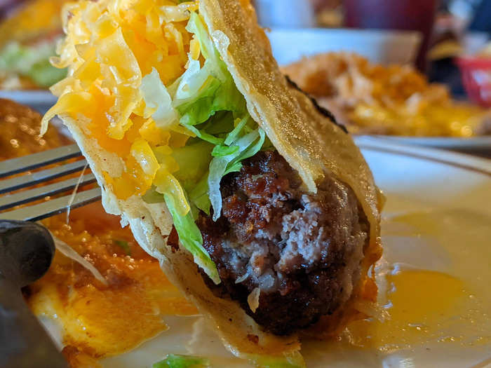 Inside the tortilla, Mitla Cafe uses a heavily-spiced ground beef patty rather than loose ground beef.