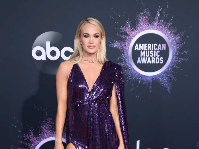 Underwood wore this deep-purple sequined gown with a high slit at the American Music Awards in November 2019.