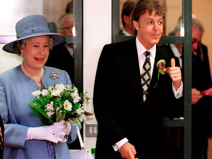 Queen Elizabeth posed with former Beatle Paul McCartney at the Liverpool Institute For Performing Arts in 1996.