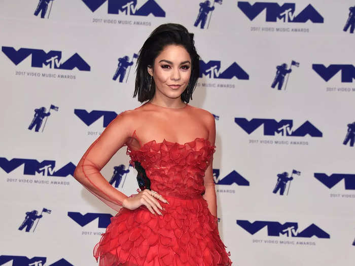 She then attended the 2017 MTV VMAs in a red, strapless minidress with a long-sleeved overlay. The latter had mesh panels and two thick rows of fabric shaped like flower petals.