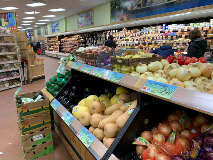 Most of the produce is loose on multi-tiered shelves.