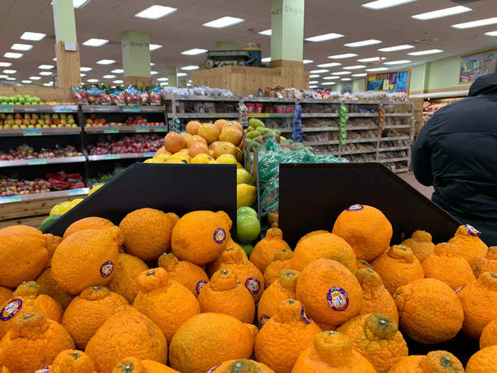 The produce section is right in front of the flowers.