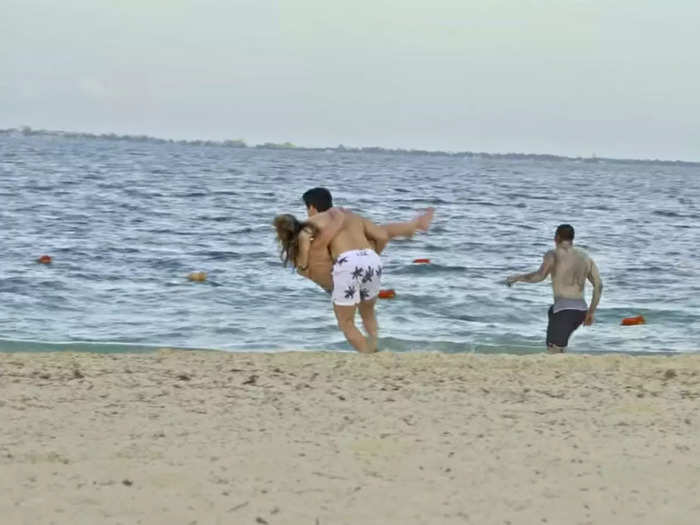 Sal wiped out with Mallory in his arms, sending them both tumbling in the sand.