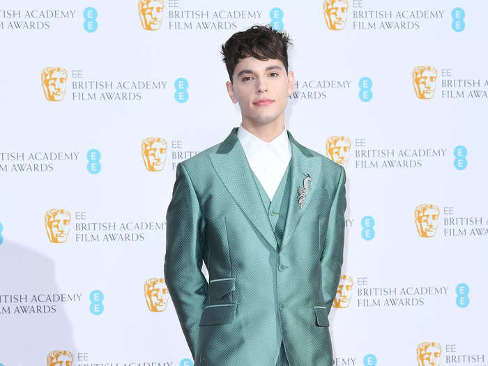 Max Harwood stood out in a muted turquoise suit and silver-tipped white boots.