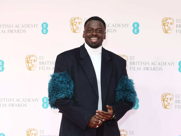 Daniel Kaluuya shook up his ensemble with a feather-trimmed Prada overcoat.