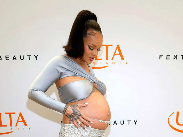 Celebrating the launch of Fenty Beauty at Ulta Beauty, Rihanna wore a silver crop top and sparkling column skirt with a belly chain.