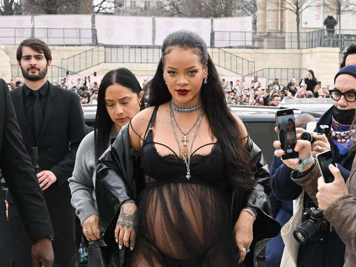 Rihanna took maternity style to new heights by wearing black lingerie to the Dior show at Paris Fashion Week.