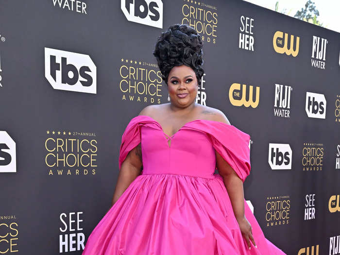 "Nailed It" host Nicole Byer stunned in a neon pink Christian Siriano gown, which she paired with an up-do hairstyle.