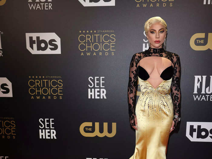 Lady Gaga went all out in a vibrant black and gold Gucci ensemble with a train.