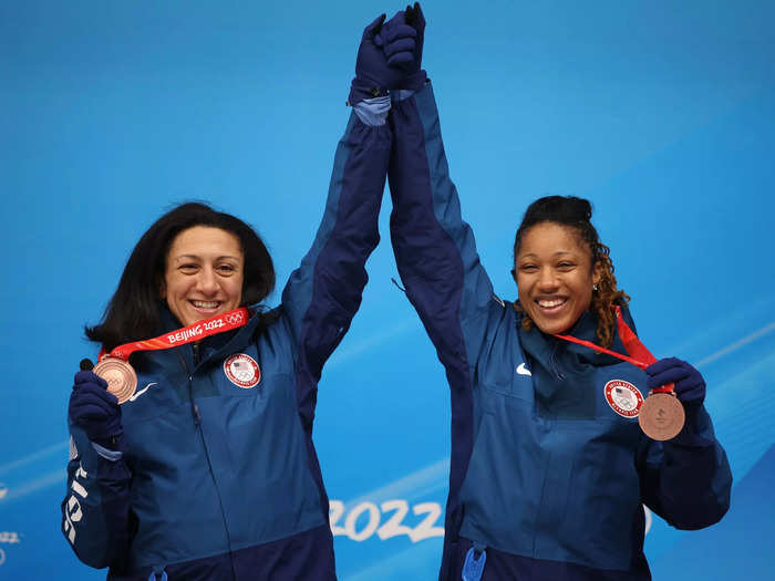 2/19: Bronze medal winners Elana Meyers Taylor and Sylvia Hoffman of Team USA pose for a photo with their medals during the flower ceremony following the 2-woman Bobsled at Beijing Olympics.
