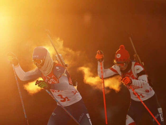 2/5: Anais Chevalier-Bouchet of Team France skis during Mixed Biathlon 4x6km relay at the Beijing Olympics.
