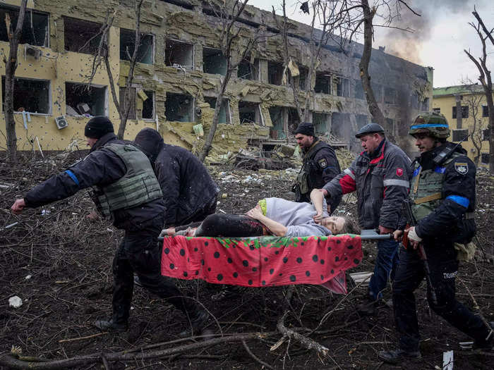 Mariupol has been under siege by Russian forces since February 24. The photo below shows a pregnant woman being carried by emergency workers after the city