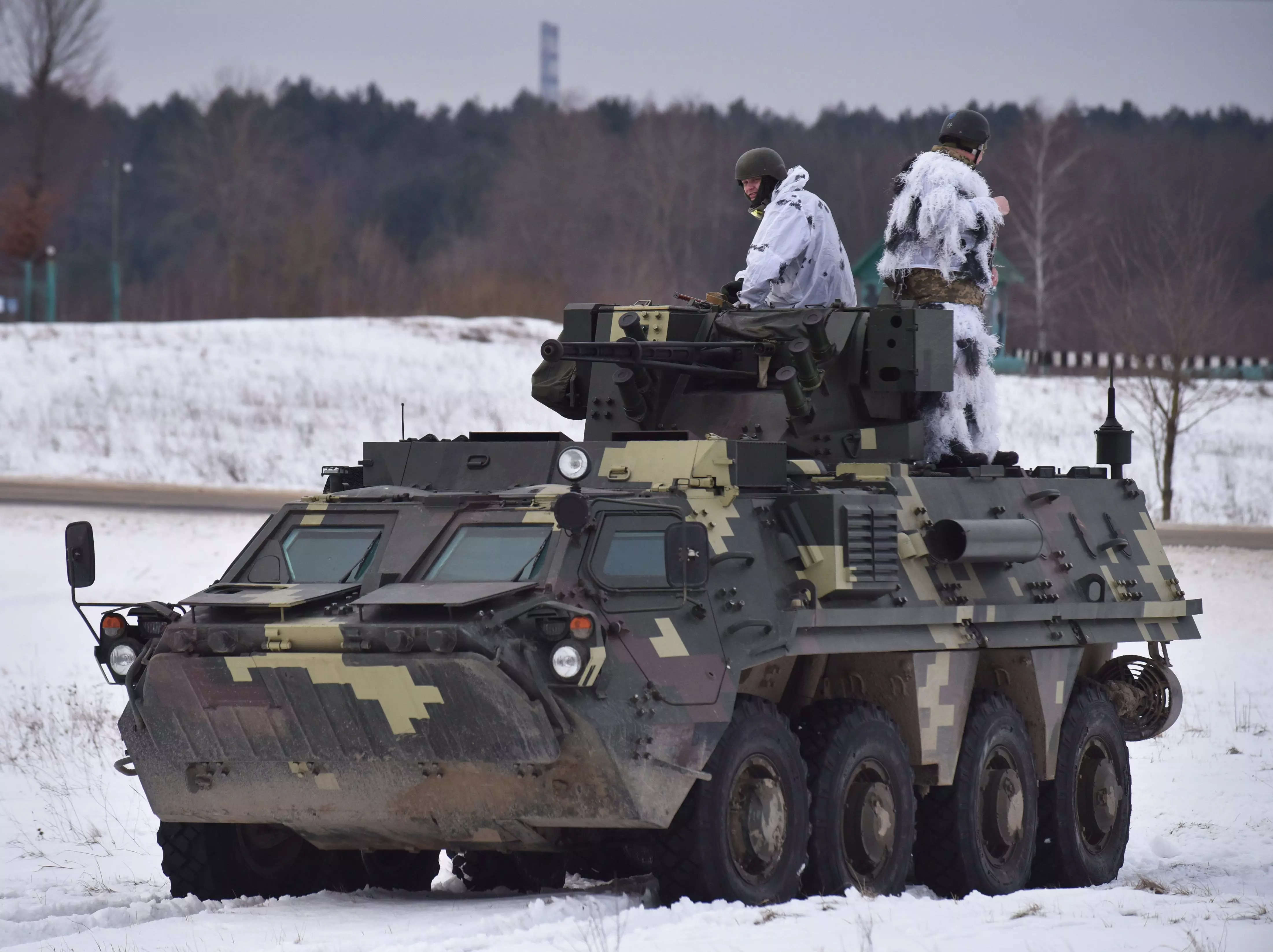 LVIV, UKRAINE - 2022/02/04: Ukrainian soldiers ride on top of the BTR-4 "Bucephalus" during the weapons training exercise at the training ground at the International Center for Peacekeeping and Security