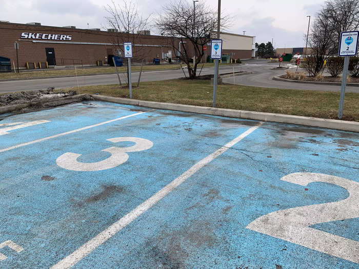 This location has four designated curbside spots near the side of the parking lot.