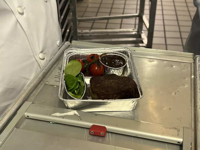 The specific food I saw in the cooler was going on a transatlantic flight Tuesday evening and would be served in business or first class cabins. The food had a green stripe on the container to indicate to workers that the food was made the night before.