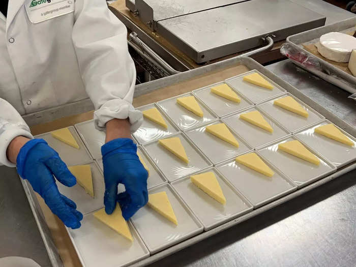 Professional cooks prepare the entrees and core parts of the meal, while other workers are responsible for cutting simpler things like fruit and cheese and preparing them as side dishes or snacks.