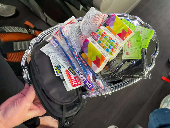 At the start of the trip, Liz offered the passengers a tray of items like eye masks, tissues, earplugs, toothbrushes, and Advil.