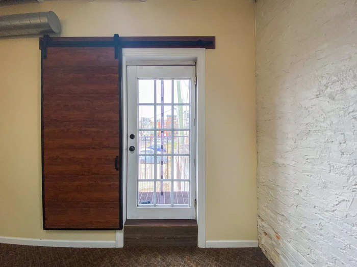 But one thing I prefer about the Baltimore bedroom is the balcony, past a sliding barn door and another windowed door.