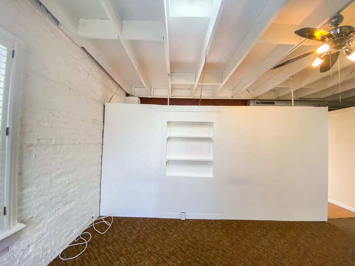 The bedroom in the Baltimore apartment is separated by a partial wall with no door. It has a ceiling fan, which would really come in handy in the summer.