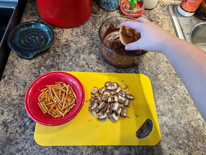 It was finally time to add my melted chocolate, Twix pieces, and pretzel bits to the cookies.