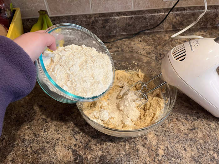 Next, I added the small bowl of flour, baking soda, and salt to the dough. The key here is to add it bit by bit to make incorporation easier.