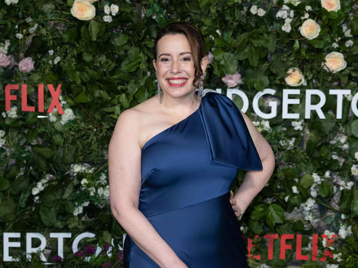 Julia Quinn, the writer of the books that "Bridgerton" is based on, arrived at the red carpet in a navy blue ball gown.