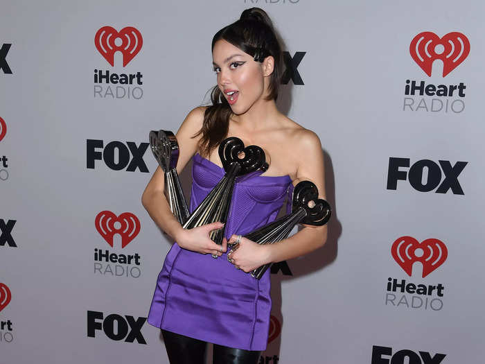Olivia Rodrigo opted for a purple minidress and thigh-high leather boots for the event, where she bagged three awards.