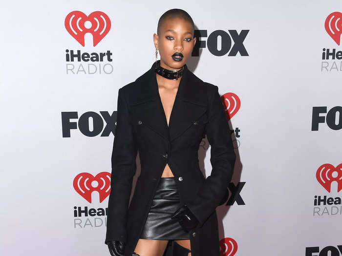 Willow Smith chose an all-black ensemble with a choker, floor-length coat, thigh-high boots, and black lip color.