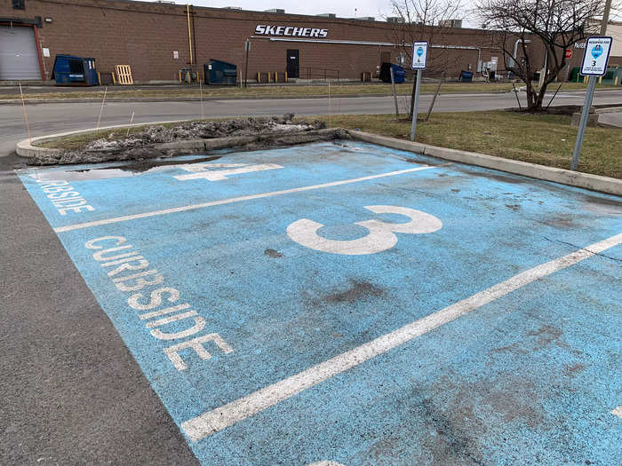 This location has four designated curbside spots near the side of the parking lot.